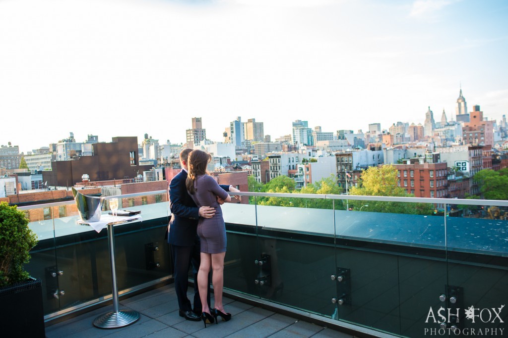 couple looking at NYC skyline on rooftop