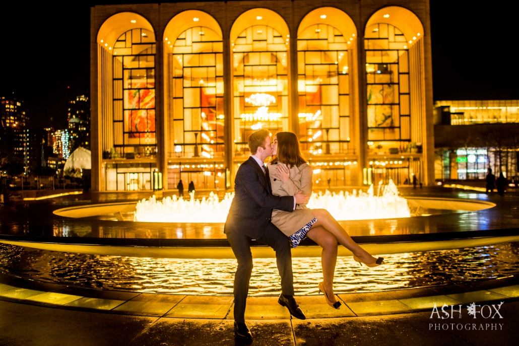 couple in front of fountain kissing