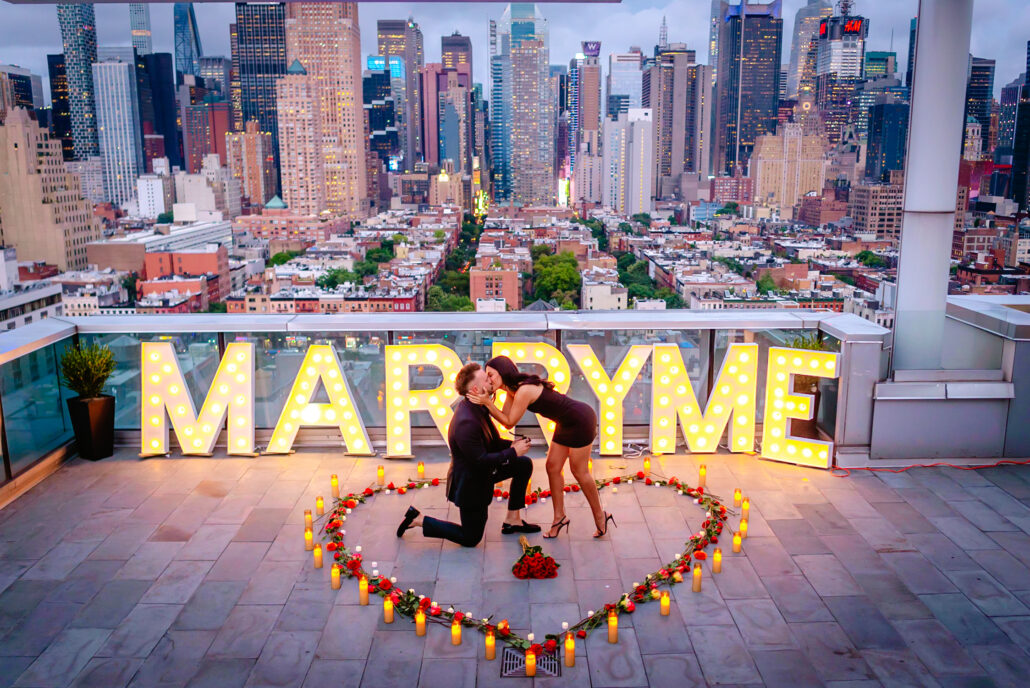 Marry Me in lights on a New York City rooftop 