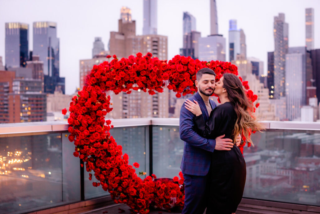 Stunning red roses standing arch in NYC for a surprise marriage proposal on a private rooftop