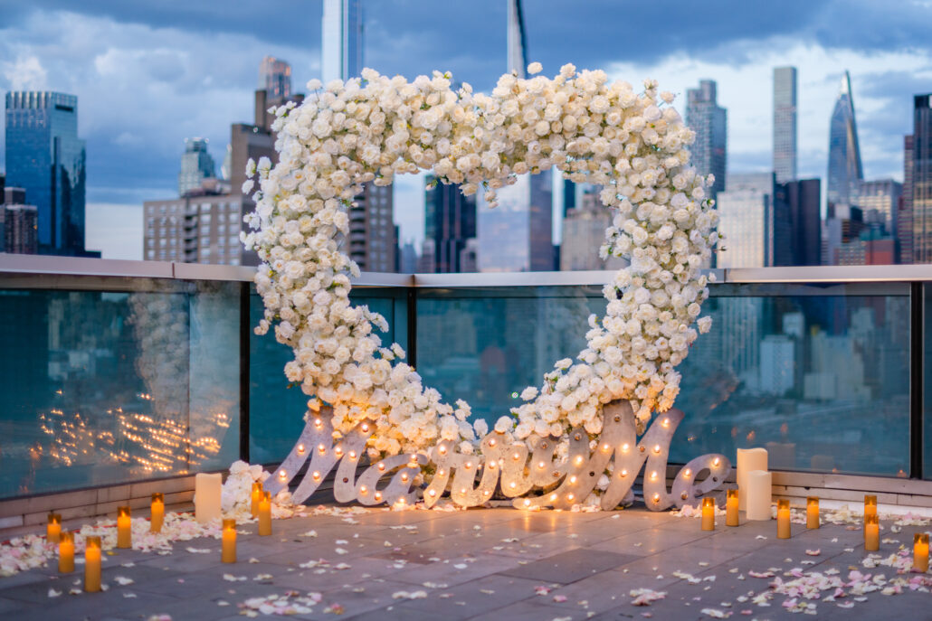 Giant marriage proposal heart arch on an NYC rooftop featuring hundreds of silk roses