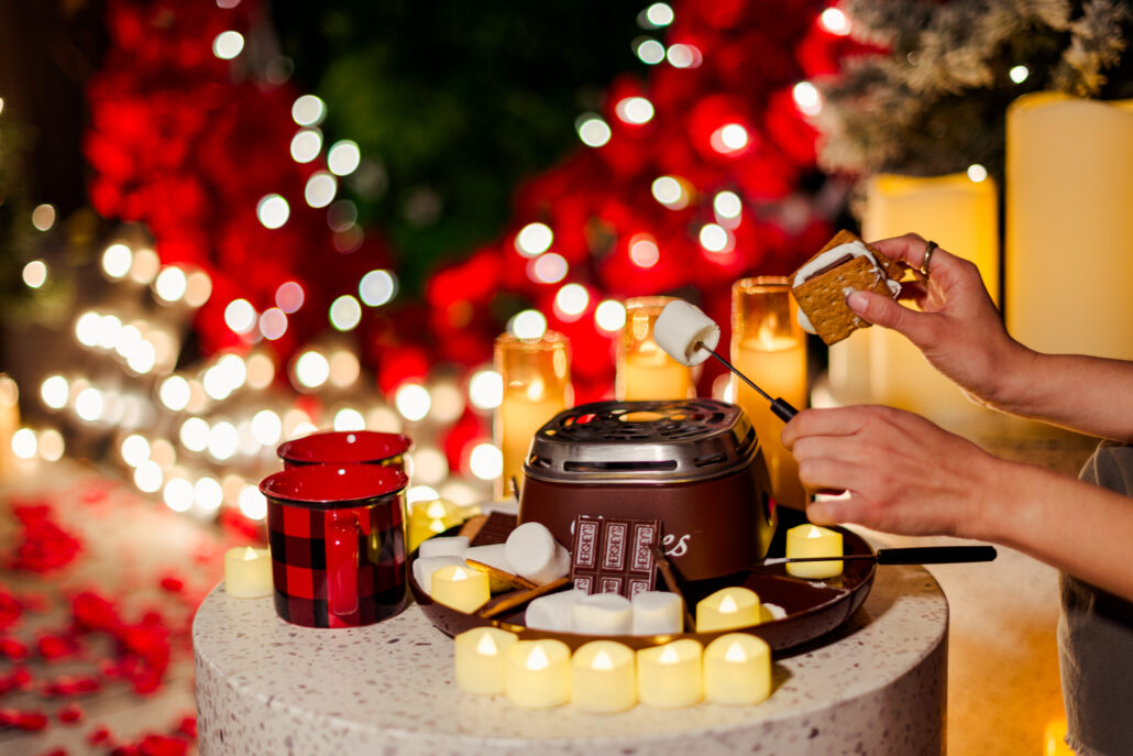 Christmas themed marriage proposal planning in NYC on a private rooftop with s'mores and hot chocolate 
