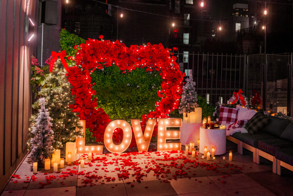 Marriage proposal planning in NYC on a private rooftop with a Giant heart and Christmas trees