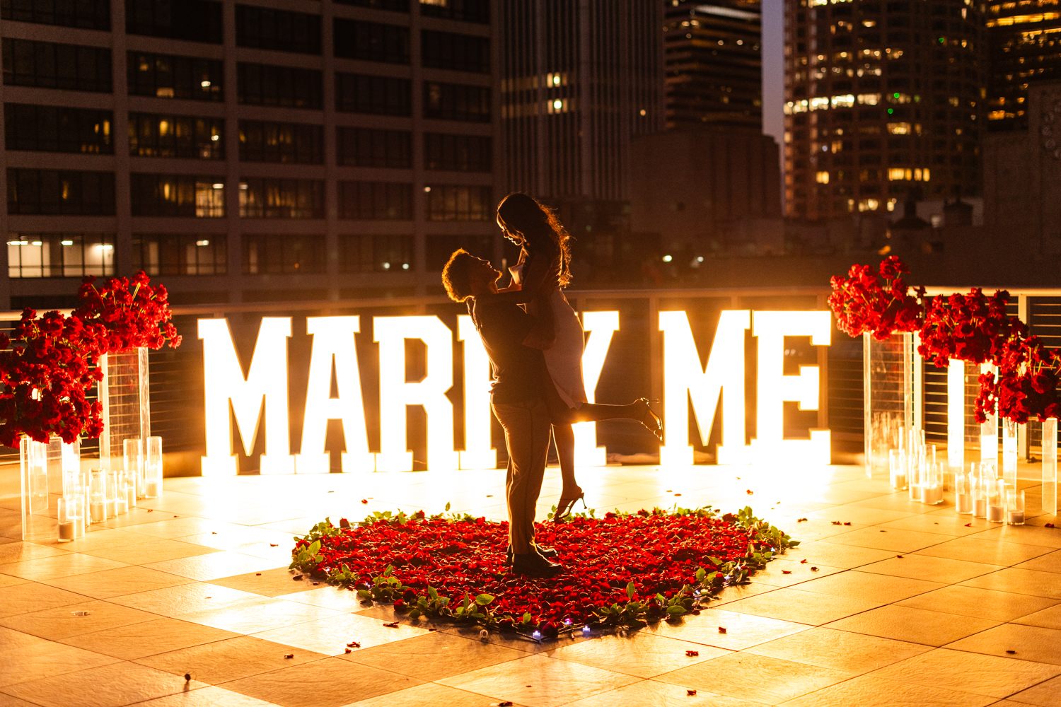 LA rooftop proposal with “MARRY ME” sign and city skyline